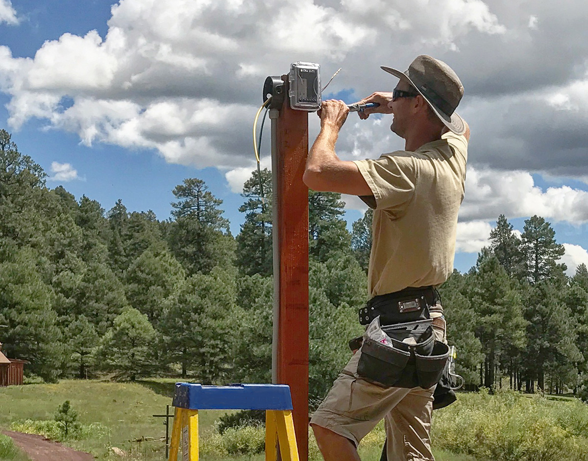 Electrician working on a ladder at a home in Flagstaff Arizona